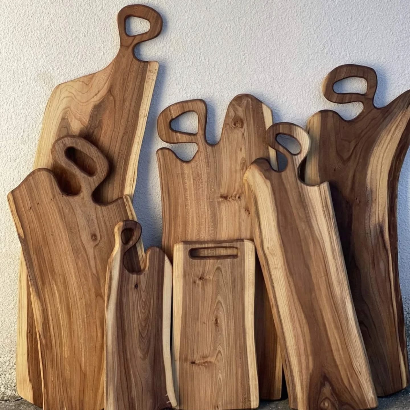 Collection of handcrafted live edge charcuterie boards with carved handles — Calgary Wood Works