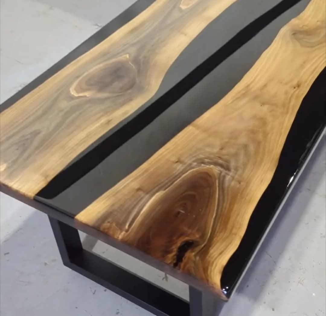 Live edge walnut black epoxy river coffee table close-up — dramatic grain and gloss finish