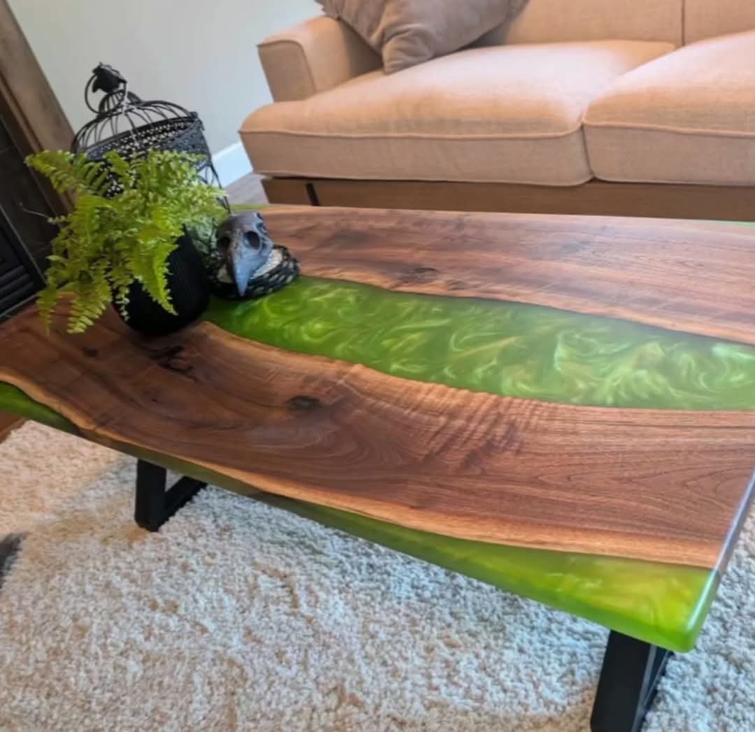 Live edge walnut green metallic epoxy river coffee table with black Z-base in living room