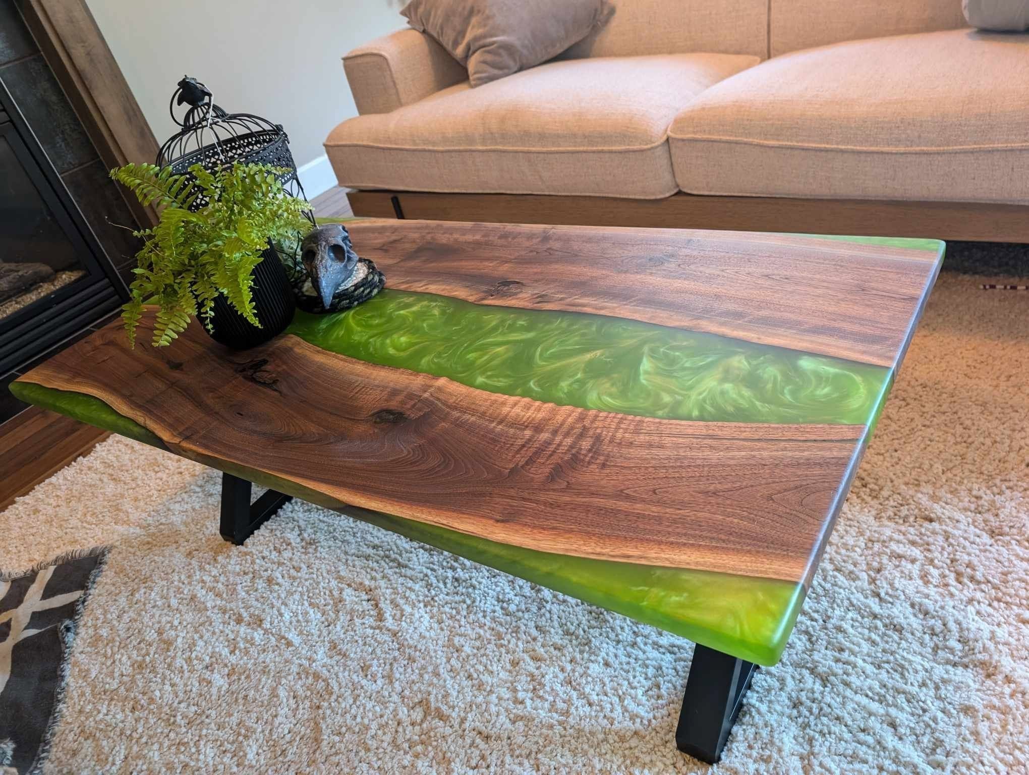 Live edge walnut coffee table with swirling green metallic epoxy river — styled Calgary living room with fireplace
