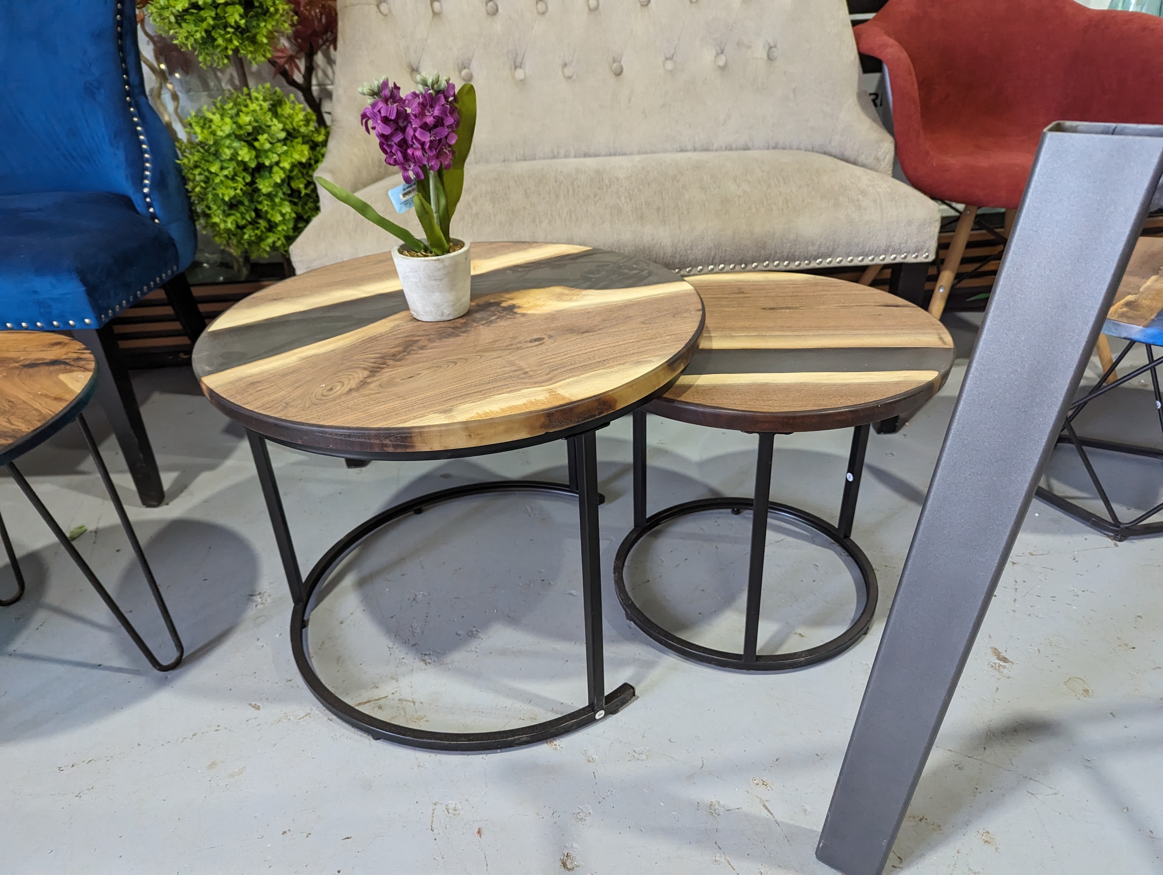 Round walnut black epoxy nesting coffee table set with circle base in shop display