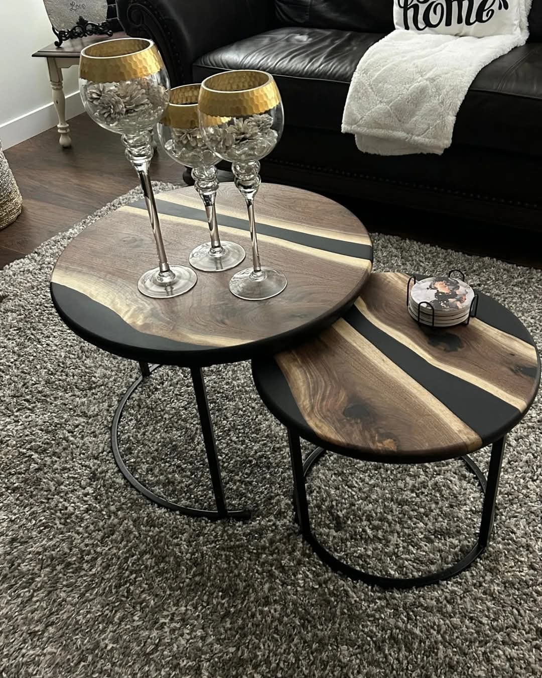 Round walnut epoxy nesting side tables styled in living room