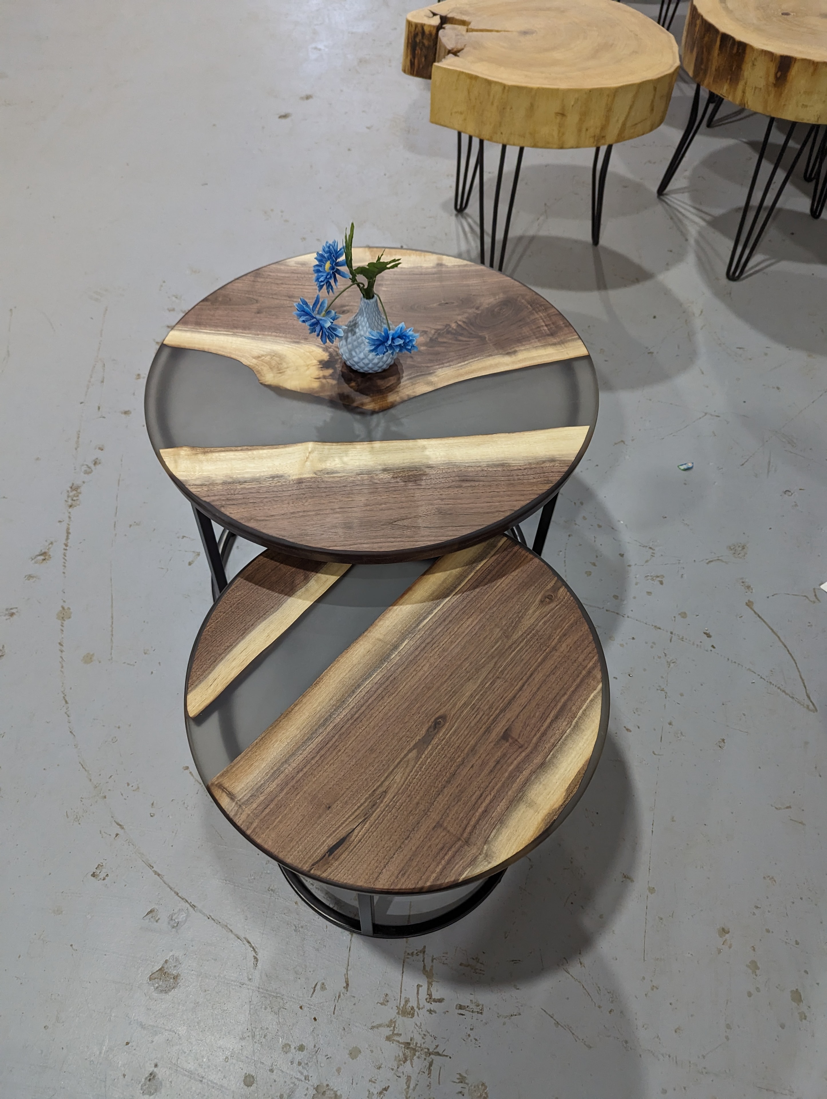 Round walnut grey epoxy nesting coffee table set displayed in Calgary Wood Works shop