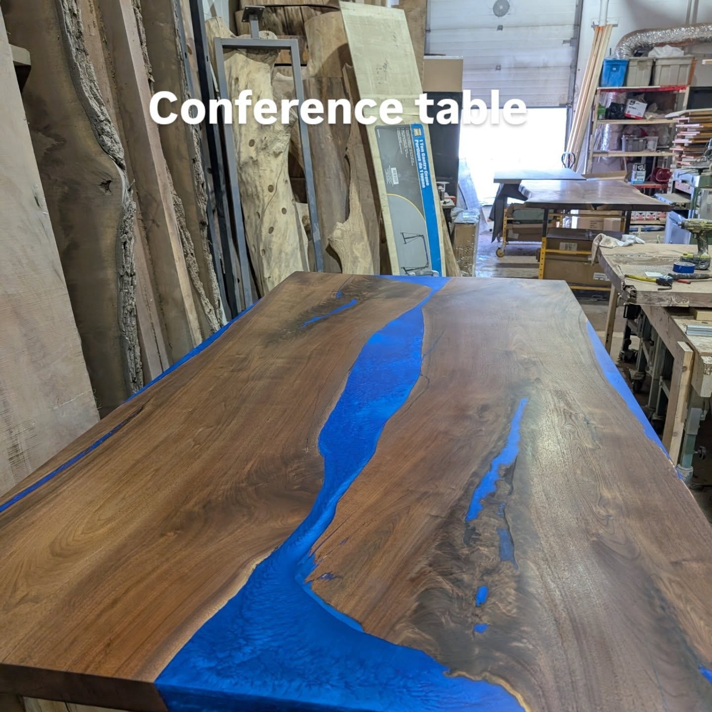Bookmatched black epoxy conference table with chrome chairs