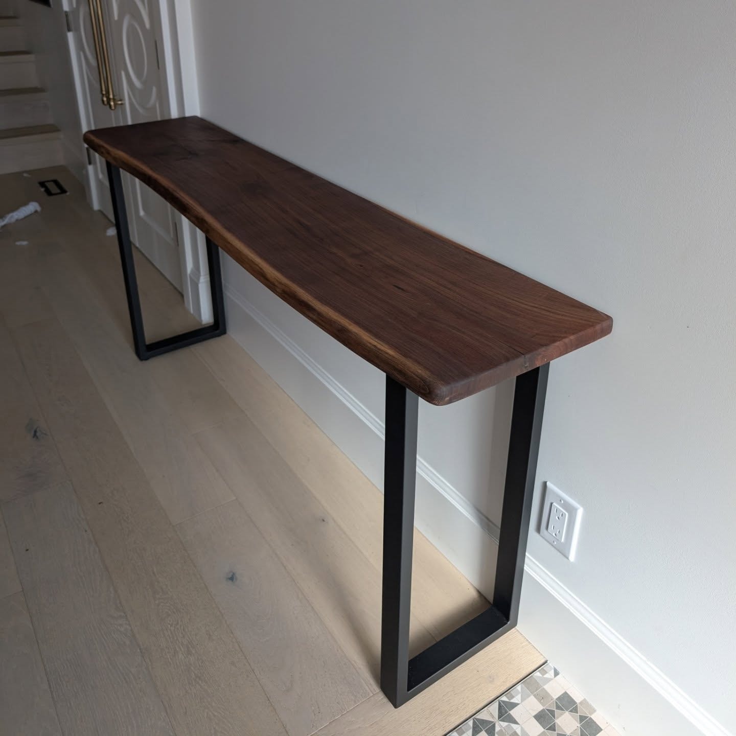 Walnut live edge console table in hallway — Calgary