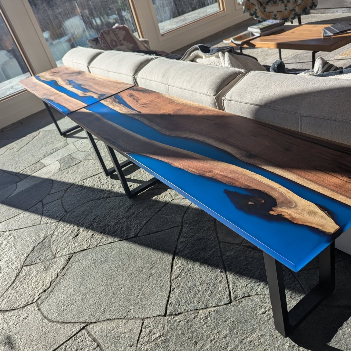Live edge walnut blue epoxy river couch table with hairpin legs in sunroom
