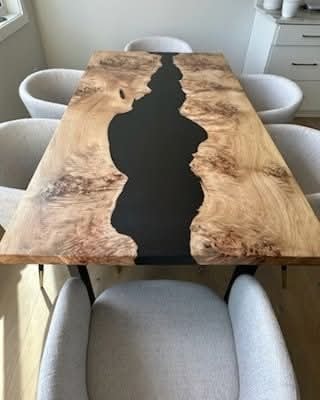 Live edge walnut burl black epoxy river dining table with white chairs