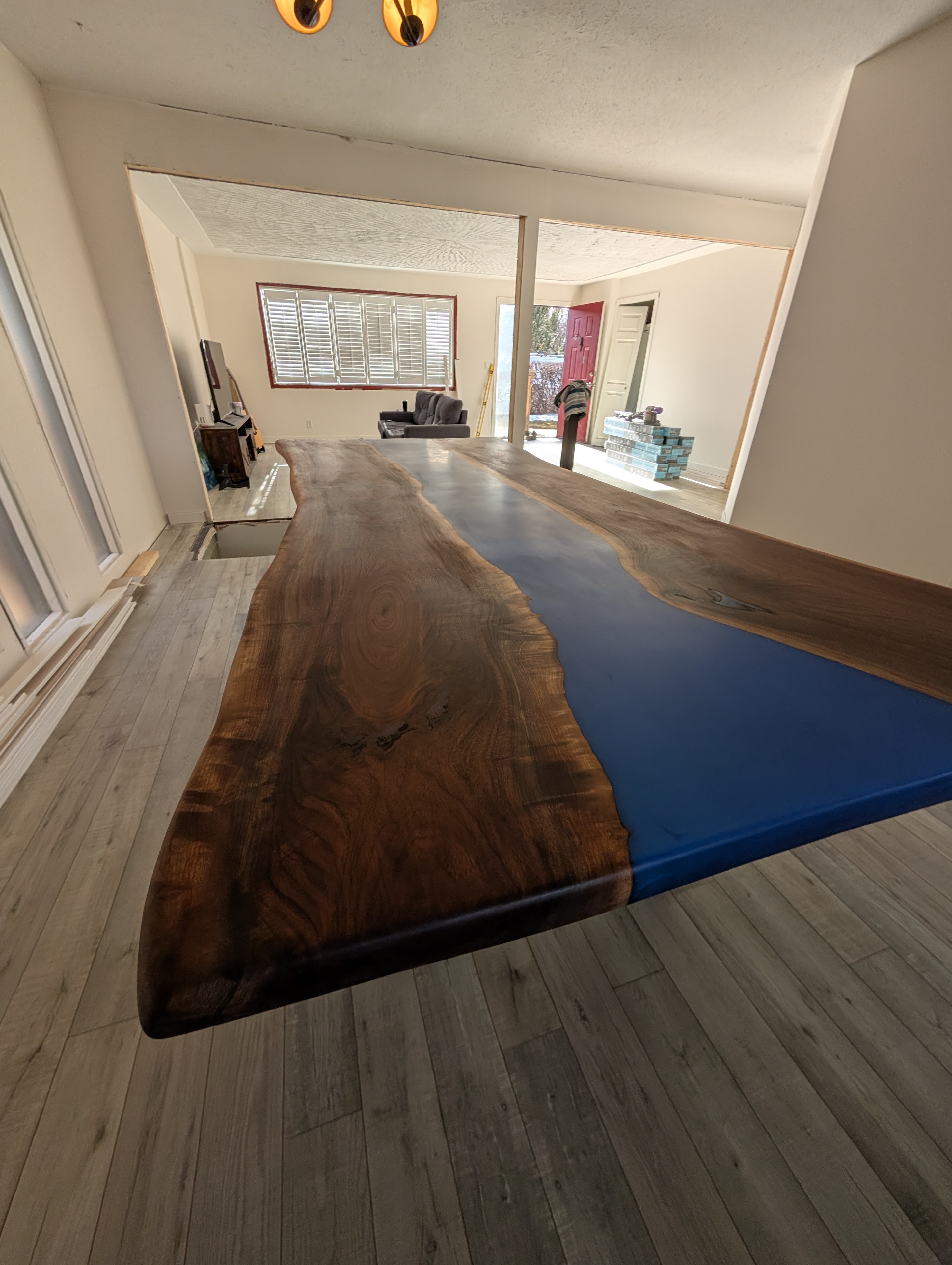 Long blue epoxy river walnut dining table