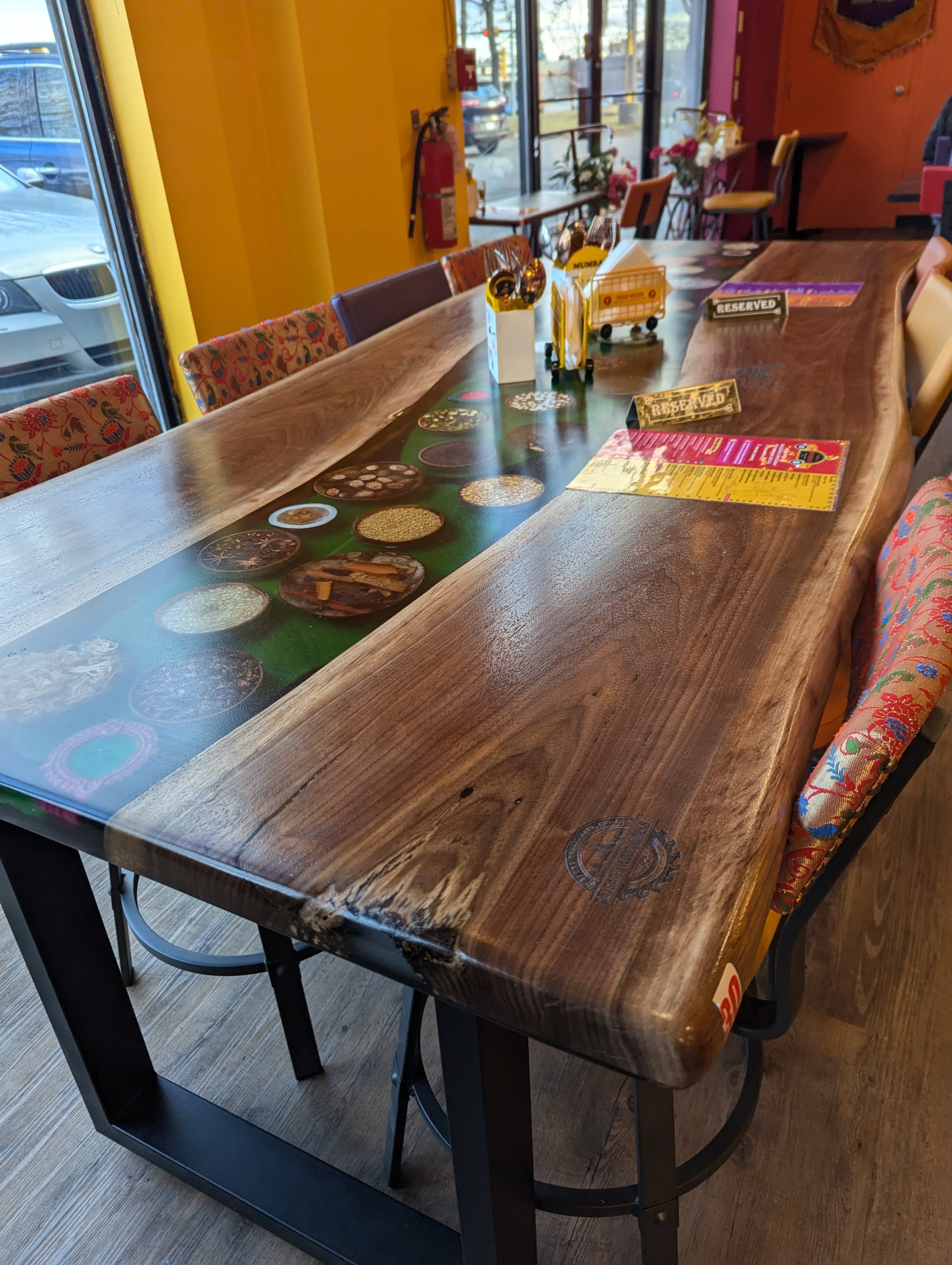 Live edge walnut green epoxy river table installed in Calgary restaurant