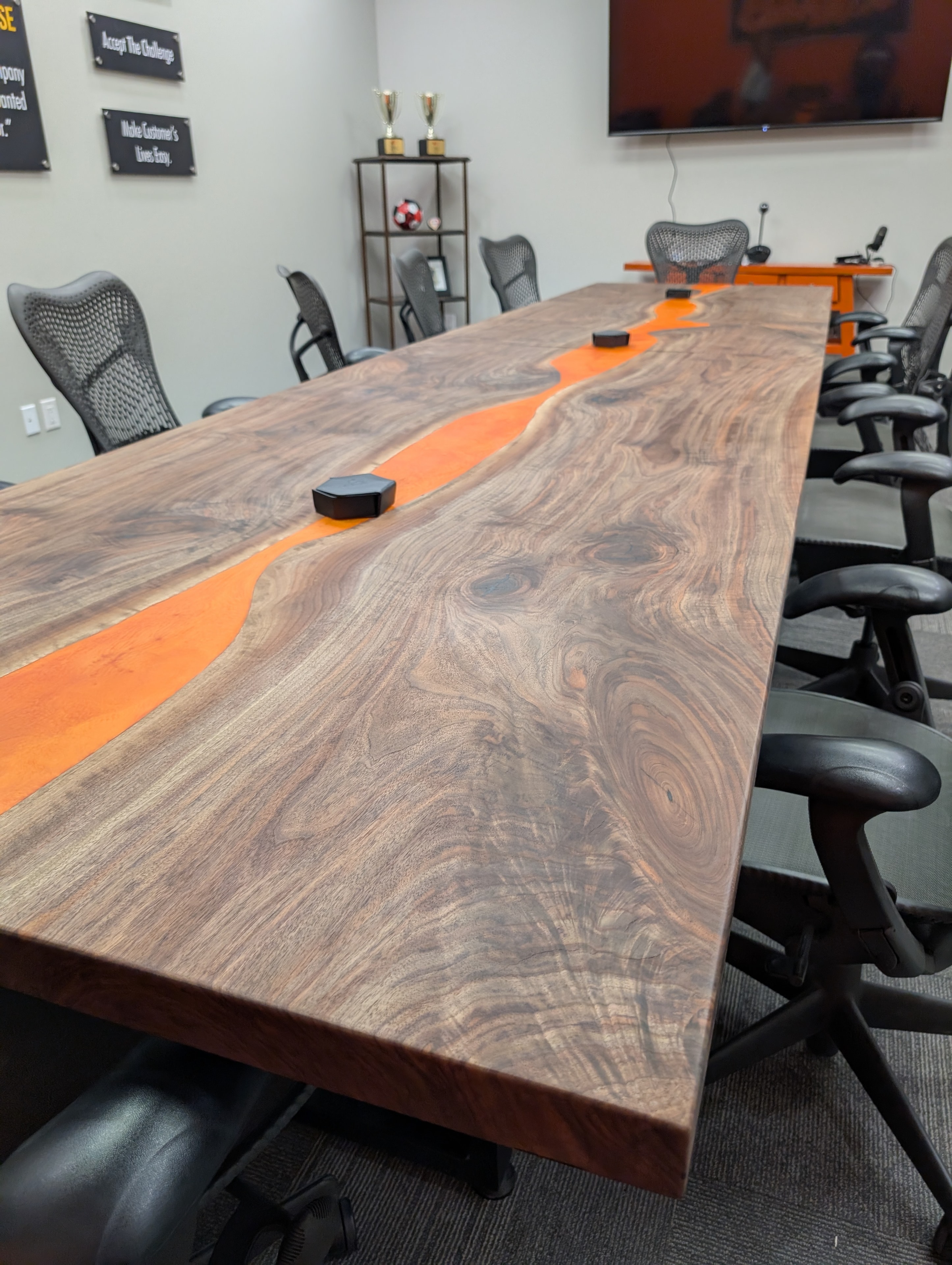 Live edge walnut orange epoxy river dining table - Calgary boardroom installation