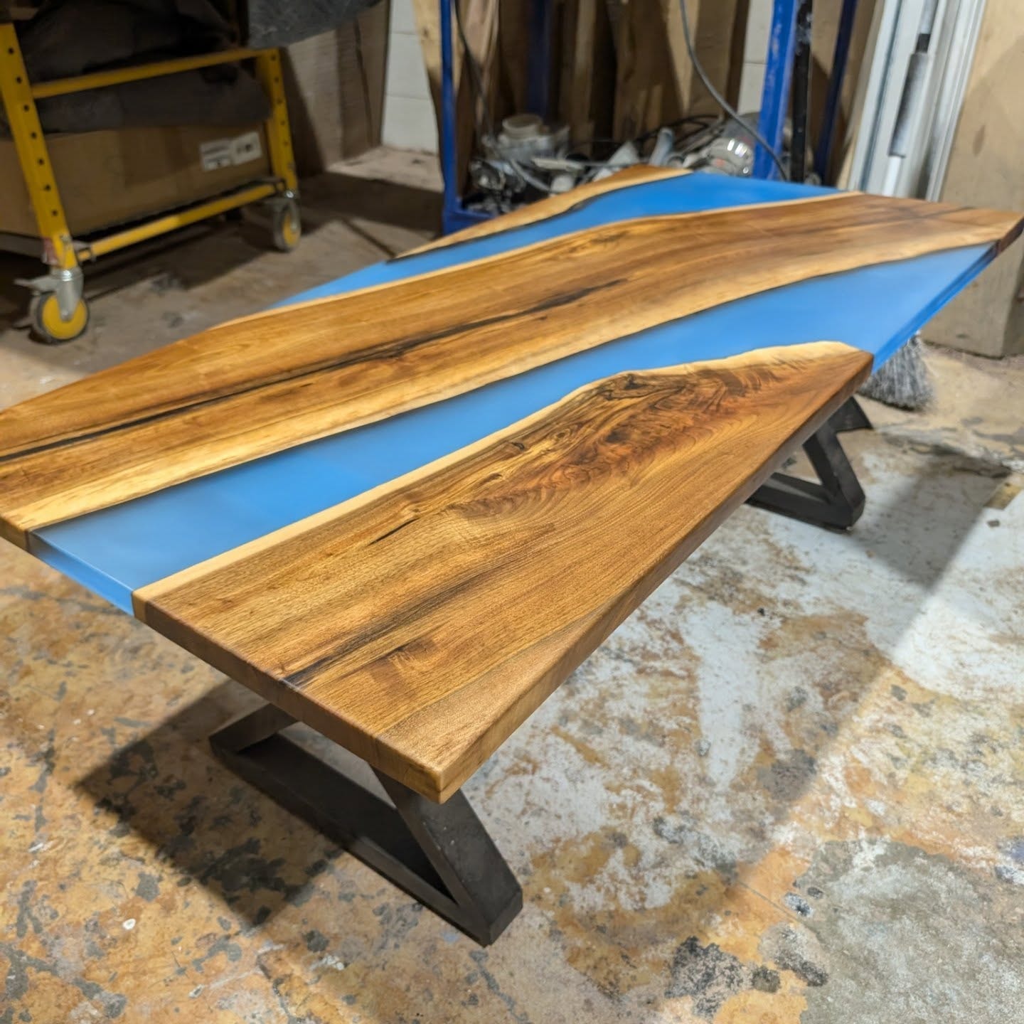 Massive spalted maple black epoxy river dining table — wide shop view showing dramatic knot and burl detail at Calgary Wood Works