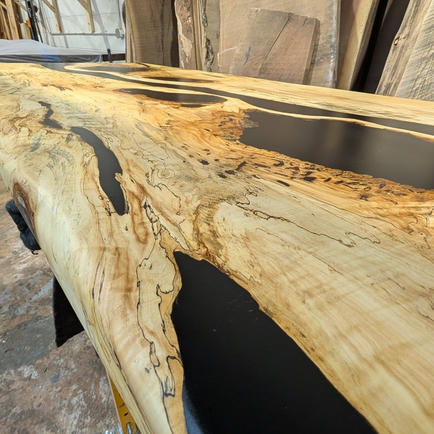 Live edge walnut black epoxy river dining table with white leather chairs — Christmas holiday styled Calgary home