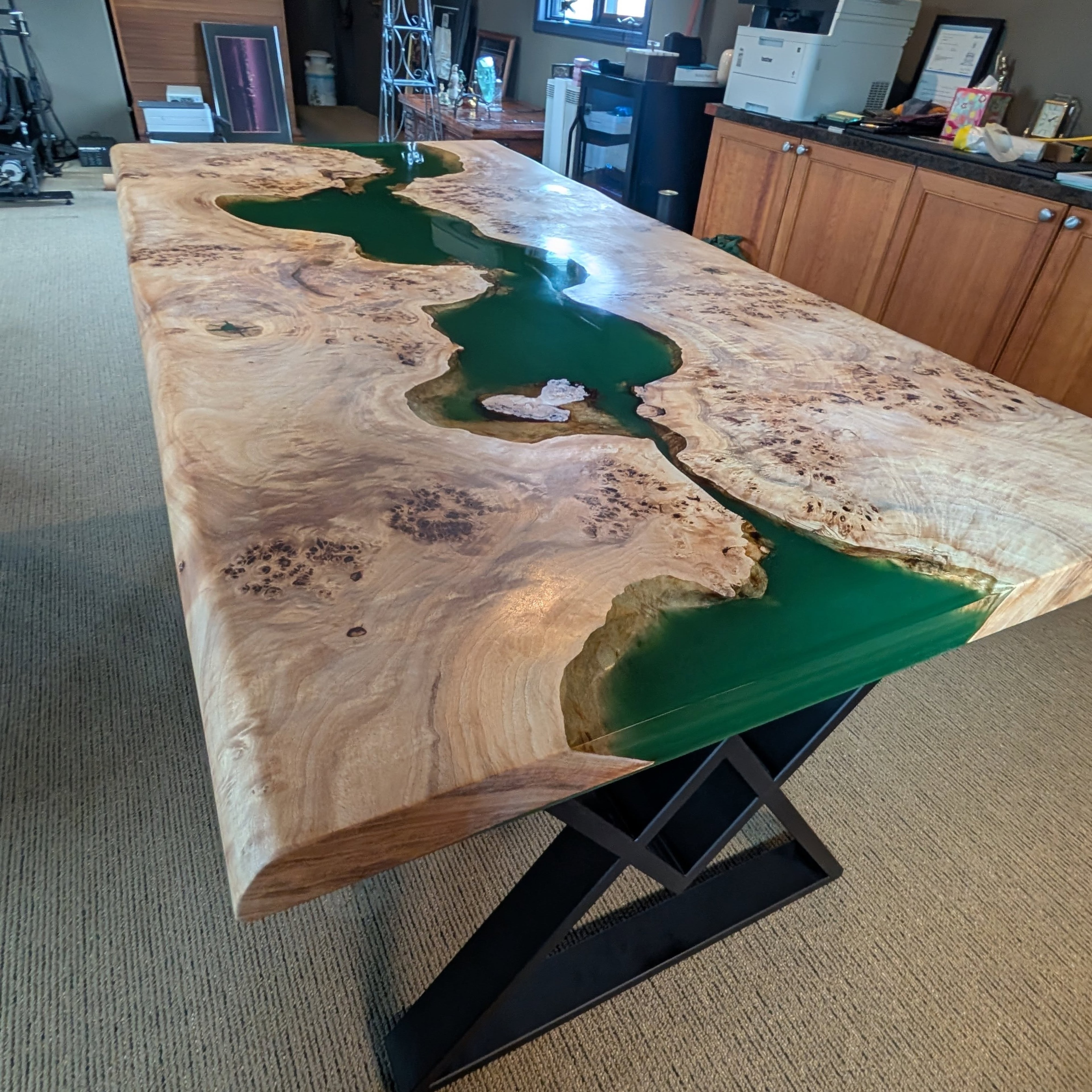 Massive maple burl green epoxy river dining table with X-base — stunning office installation Calgary Wood Works