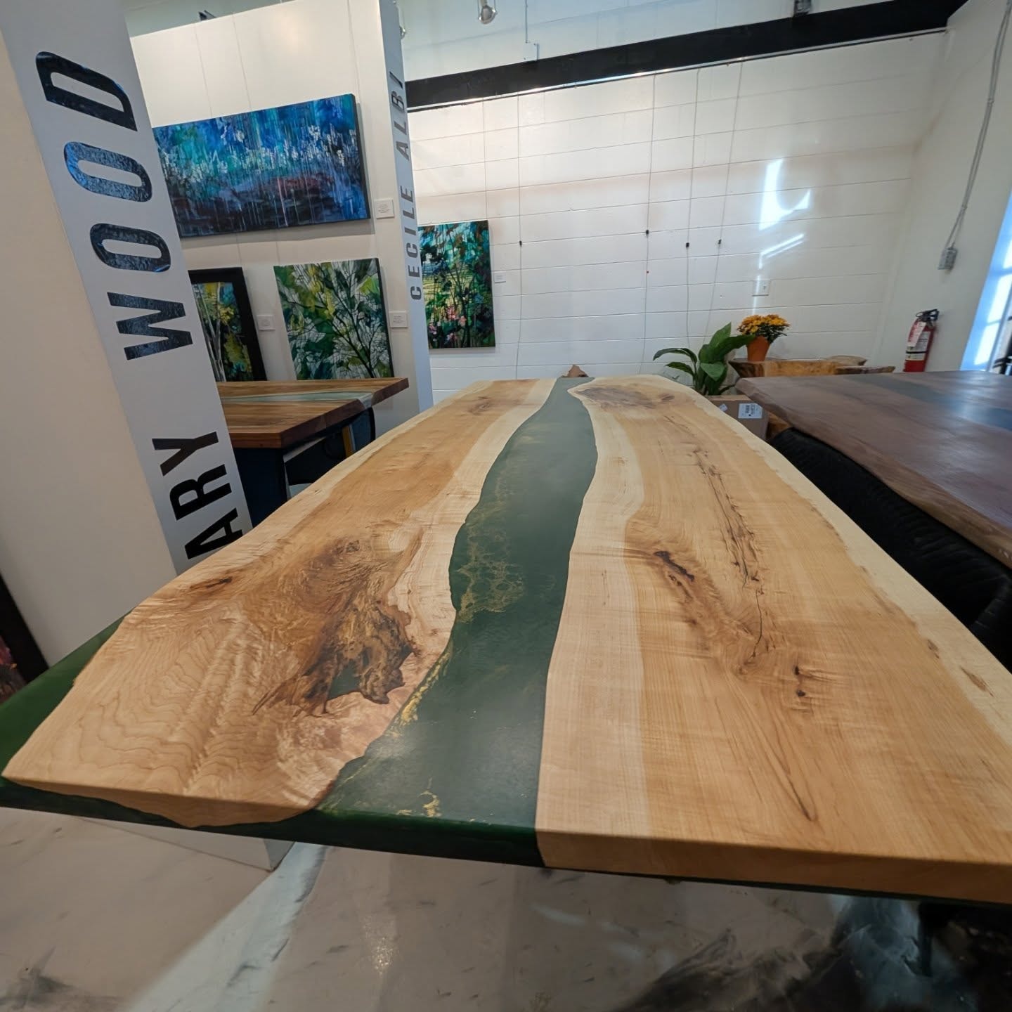 Massive spalted maple green epoxy river dining table in progress — wide shop view at Calgary Wood Works