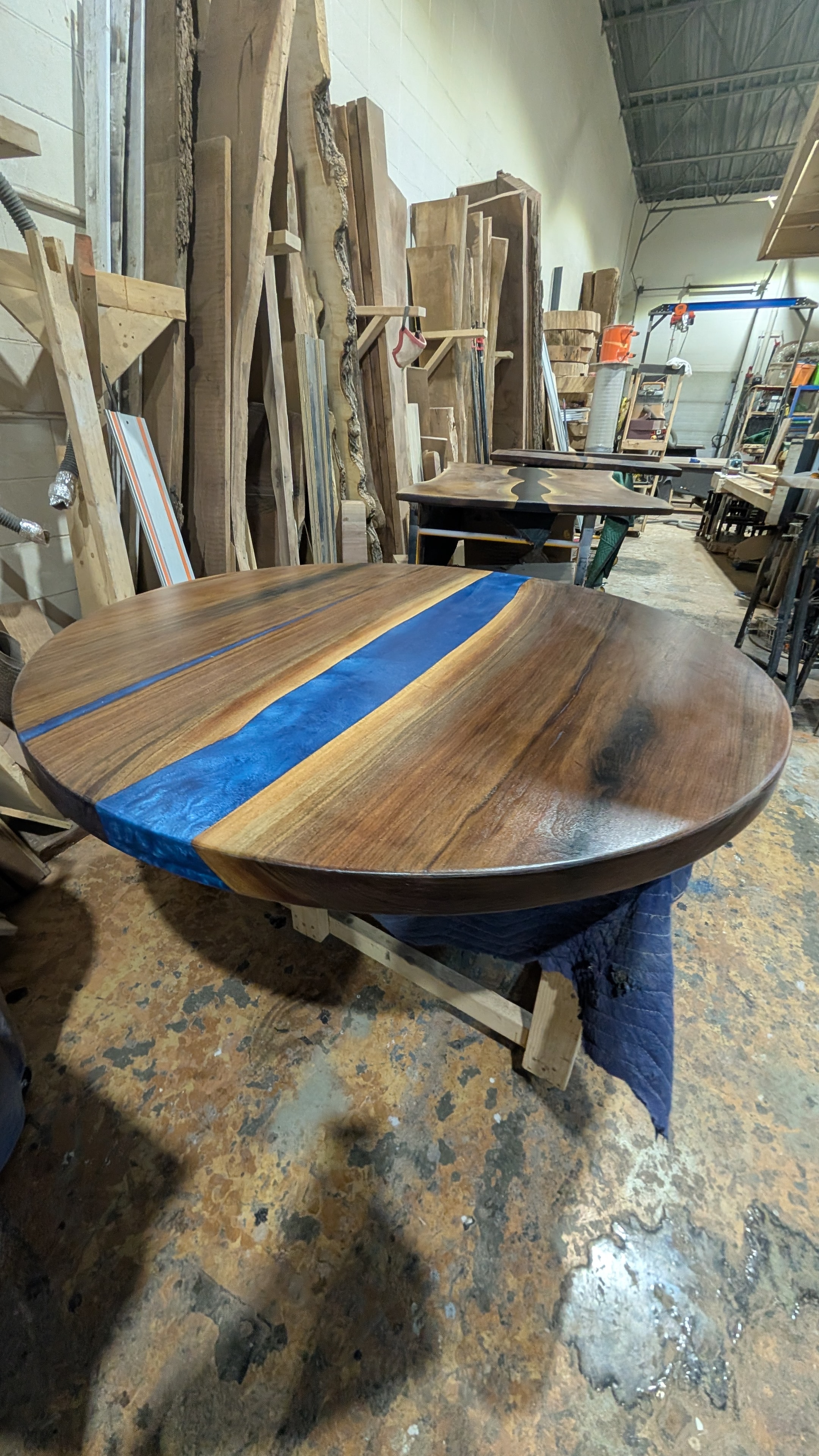 Blue epoxy river dining table with walnut slabs