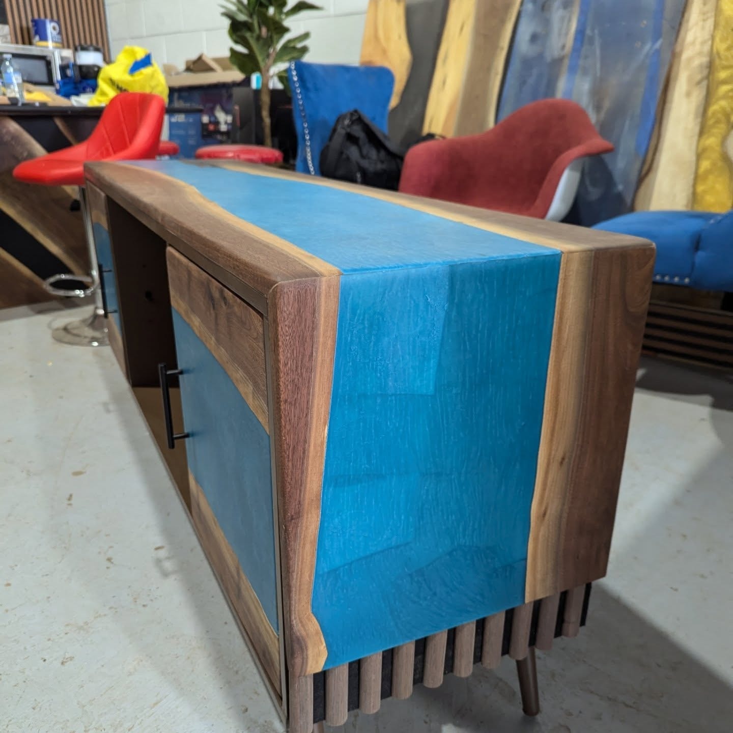 Custom walnut hutch with blue epoxy and slat legs