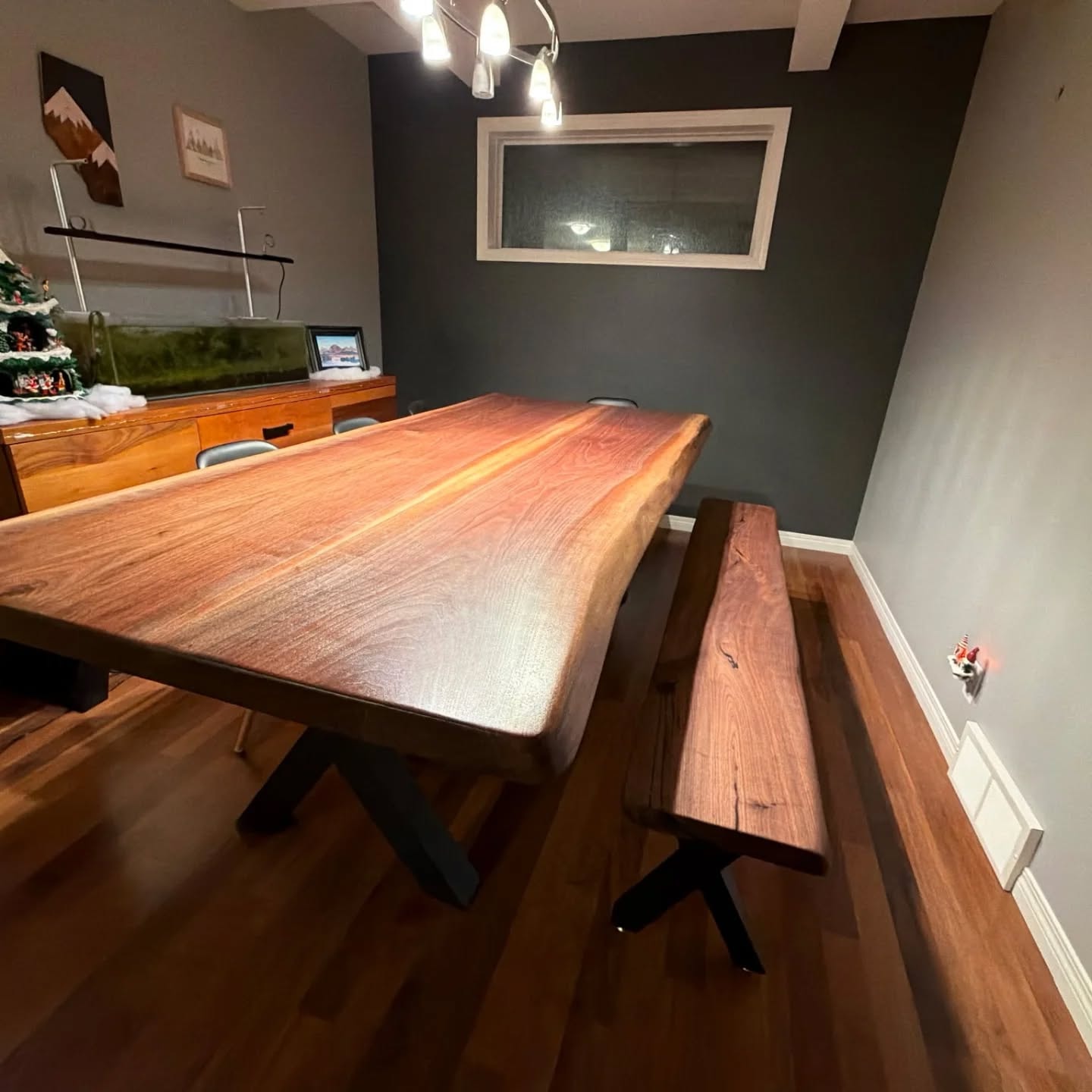 Solid walnut live edge dining table with matching bench and X-base legs — cozy Christmas dining room
