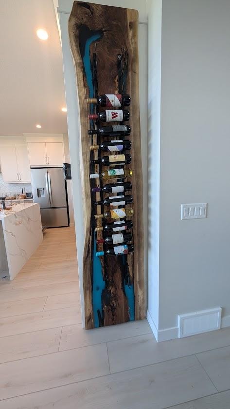 Blue epoxy walnut wine rack wall installed — Calgary